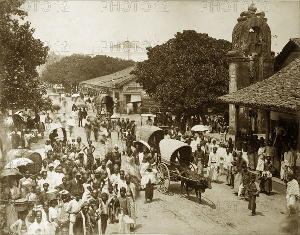 Main street of Colombo. The main street bustling with crowds and cattle-drawn carts. Colombo, Ceylon (Sri Lanka), circa 1885. Colombo, West (Sri Lanka), Sri Lanka, Southern Asia, Asia.