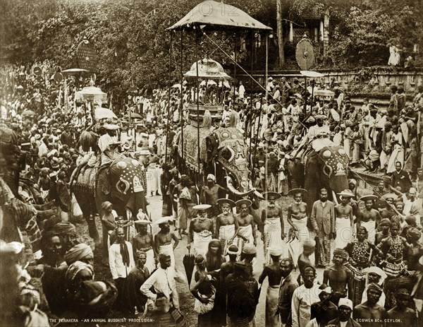 Buddist perahera in Ceylon. Crowds of people pack the streets at an annual Buddhist perahera (procession) in honour of the Sacred Relic of the Buddha's Tooth. The procession is headed by three decorated elephants. Kandy, Ceylon (Sri Lanka), circa 1885. Kandy, Central (Sri Lanka), Sri Lanka, Southern Asia, Asia.