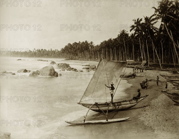 Fishing boat and crew, Ceylon. Groups of fishermen survey the sea, their boats moored on the beach. Ceylon (Sri Lanka), circa 1885. Sri Lanka, Southern Asia, Asia.