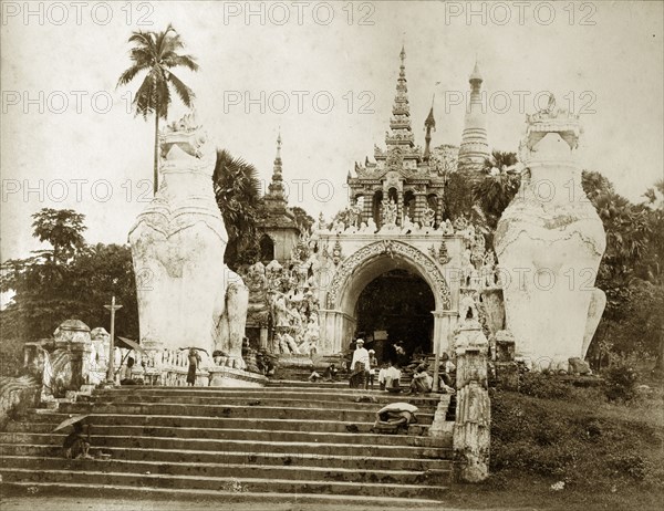 The entrance to Shwe Dagon Pagoda. The main, southern entrance to the Buddist shrine of Shwe Dagon Pagoda, protected by two 'chenthe' (half-lion, half-dragon guardian figures). Rangoon (Yangon), Burma (Myanmar), circa 1885. Yangon, Yangon, Burma (Myanmar), South East Asia, Asia.