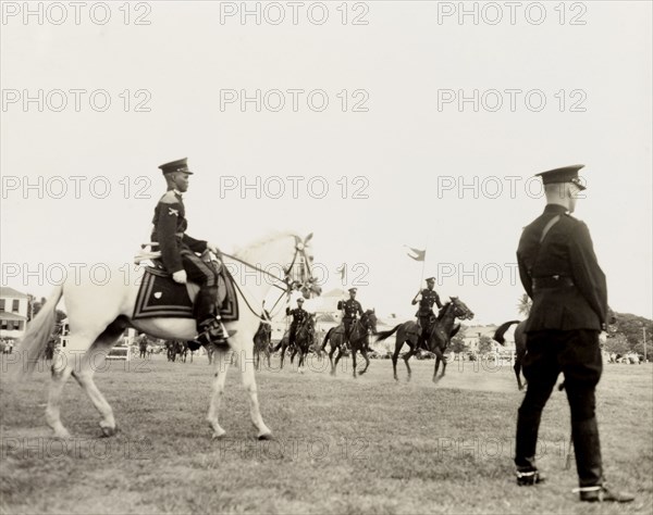 Mounted police tournament. Uniformed police officers ride their horses in a mounted police tournament being held at the Eve Leary parade ground. Georgetown, Guyana, 1948. Georgetown, Demerara-Mahaica, Guyana, South America, South America .