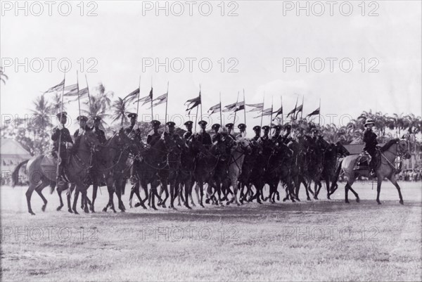 March past at the wall'. A troop of mounted police officers trot in line with flags at the Eve Leary parade ground on the occasion of King George VI's birthday. Georgetown, Guyana, 1948. Georgetown, Demerara-Mahaica, Guyana, South America, South America .