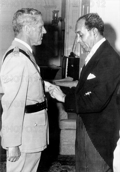 Leslie Slater receives his OBE. Sir Deighton Lisle Ward, the Governor General of Barbados between 1976 and 1984, awards Police Commandant Leslie Slater with an OBE medal. Port of Spain, Trinidad, October 1977. Port of Spain, Trinidad and Tobago, Trinidad and Tobago, Caribbean, North America .