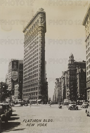 Flatiron Building. Ground level view of the Flatiron building, located on the corner of 23rd Street, Fifth Avenue and Broadway. New York, United States of America, circa 1942. New York, New York, United States of America, North America, North America .