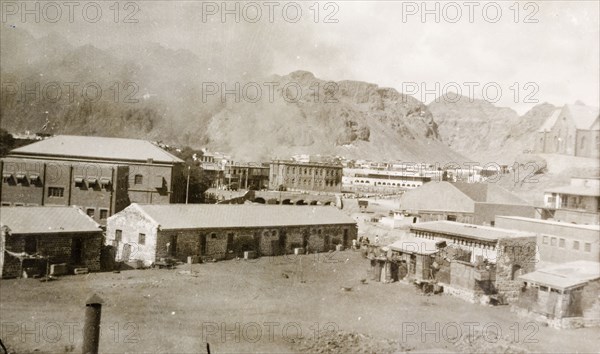 Riot damage in Aden, 1947. A plume of smoke rises from a building in the Jewish quarter of Aden, during the Arab riots that took place between 1-3 December 1947 in response to the United Nations Partition Plan for Palestine. Aden, Yemen, December 1947. Aden, Adan, Yemen, Middle East, Asia.