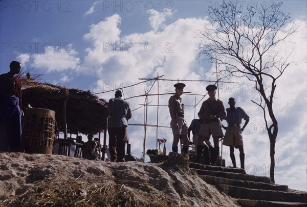 United National Independence Party rally. Policemen and organizers await the arrival of the United National Independence Party president, Kenneth Kaunda, to address UNIP supporters at a political rally. Kitwe, Northern Rhodesia (Zambia), circa 1962. Nkana-Kitwe, Copperbelt, Zambia, Southern Africa, Africa.