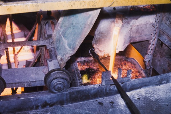 Pouring copper at Nkana-Kitwe mines. Copper is poured into a furnace during the refining process at a copper mine. Nkana-Kitwe, Northern Rhodesia (Zambia), circa 1962. Nkana-Kitwe, Copperbelt, Zambia, Southern Africa, Africa.
