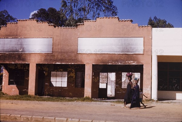 Commercial building damaged in riots, Elizabethville. A burnt and gutted commercial building in Elizabethville, which was destroyed in riots during the Congolese civil war (1960-63). Elizabethville, Republic of the Congo (Lubumbashi, Democratic Republic of the Congo), circa 1964. Lubumbashi, Haut Katanga, Congo, Democratic Republic of, Central Africa, Africa.
