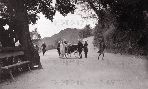 The mall', Mussoorie. Uniformed servants surround a rickshaw at 'the mall', a road junction at the hill station of Mussoorie. Mussoorie, India, circa 1890. Mussoorie, Uttaranchal, India, Southern Asia, Asia.
