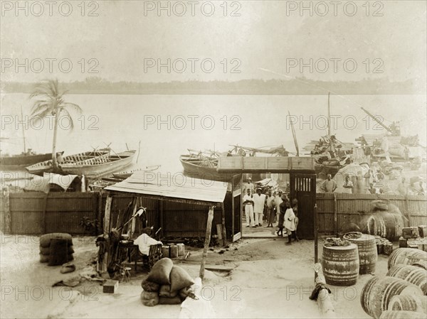 Jetty at Badagry. Cargo boats wait at a riverside jetty belonging to the African Oil Nuts Company, an organisation concerned with the production of palm oil. Badagry, Lagos, Nigeria, 1922. Badagry, Lagos, Nigeria, Western Africa, Africa.