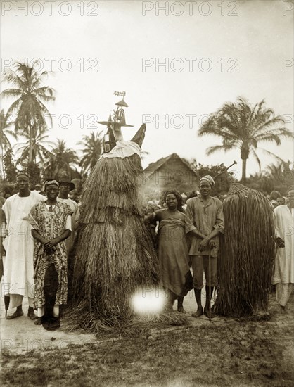 Tassled juju costumes. Two juju practioners dressed in tassled costumes designed to cover their entire bodies. Probaby Lagos, Nigeria, circa 1925. Nigeria, Western Africa, Africa.