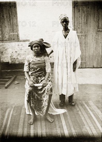 Portrait of a Hausa husband and wife. Portrait of a Hausa husband and wife, posing for the camera in traditional dress. Badagry, Nigeria, circa 1928. Badagry, Lagos, Nigeria, Western Africa, Africa.
