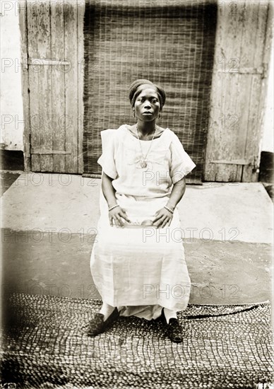 Portrait of a Nigerian woman. Portrait of a Nigerian woman, seated and looking proudly into the camera. Badagry, Nigeria, circa 1928. Badagry, Lagos, Nigeria, Western Africa, Africa.