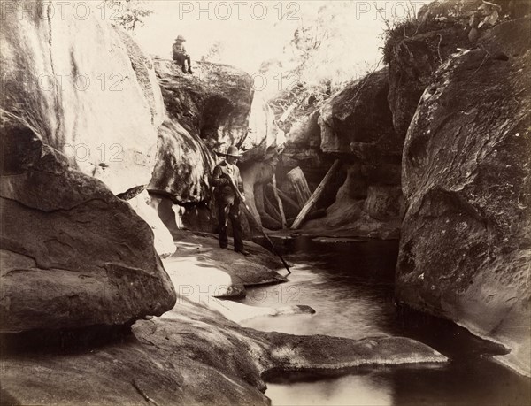 Rock pool, Australia. A man and boy pass time by a rock pool or stream. Possibly New South Wales, Australia, circa 1890. Australia, Australia, Oceania.