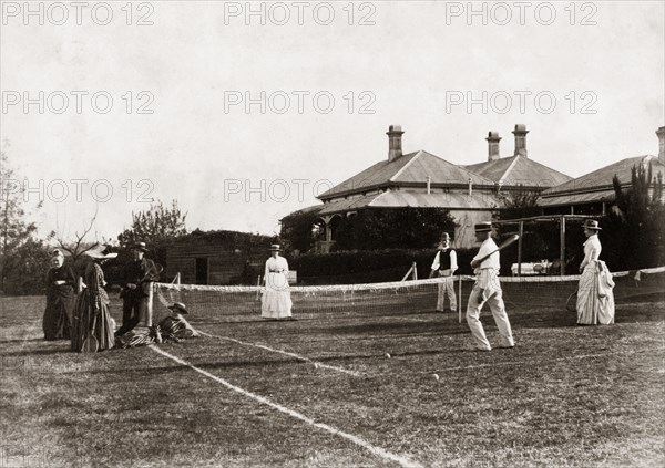 Mixed-doubles tennis match. A mixed-doubles tennis match on a grass court at 'Nundora', the house of Mrs Francis Brodribb. Toowoomba, Australia, 1890. Toowoomba, Queensland, Australia, Australia, Oceania.