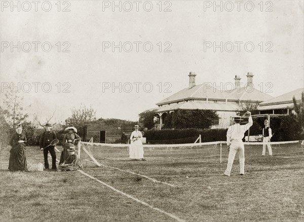 Mixed-doubles tennis match. A mixed-doubles tennis match on a grass court at 'Nundora', the house of Mrs Francis Brodribb. Toowoomba, Australia, 1890. Toowoomba, Queensland, Australia, Australia, Oceania.