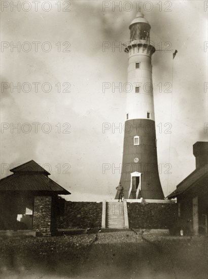 Beacon Island lighthouse. A 'G.E.W. inspector' poses on steps beside the Beacon Island lighthouse. Burma (Myanmar), circa 1900. Burma (Myanmar), South East Asia, Asia.