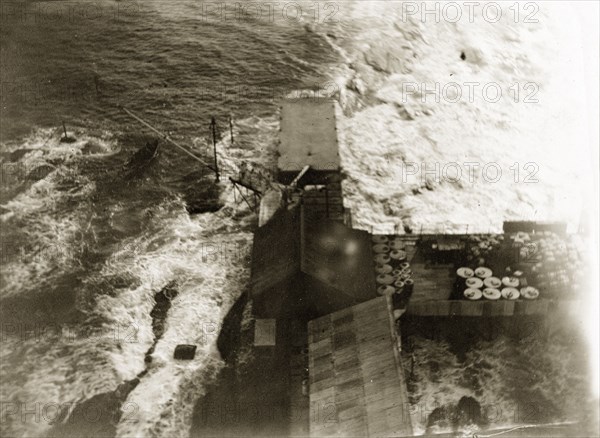 View from the Alguada Reef lighthouse. View from the top of the Alguada Reef lighthouse looking down onto rough seas crashing around the the landing stage and dock. Burma (Myanmar), circa 1900. Burma (Myanmar), South East Asia, Asia.