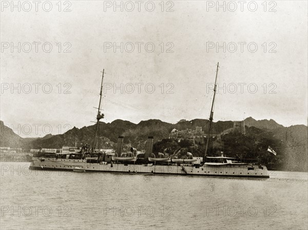HMS 'Philomel'. HMS 'Philomel', a naval steamer belonging to the Persian Gulf Operations Fleet, floats off shore. Probably the Persian Gulf, circa 1900., Middle East, Asia.