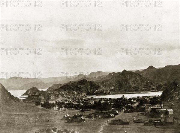 Valley outside Muscat. View across a valley outside Muscat, showing a village surrounded by mountains. Near Muscat, Oman, circa 1900., Muscat, Oman, Middle East, Asia.