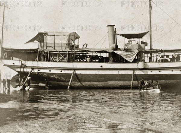 Armed launch 'Miner' awaits repairs. Armed launch boat 'Miner', a vessel belonging to the Persian Gulf Operatations Fleet, is grounded on a beach, awaiting repairs to her propellers and shafts. Persian Gulf, circa 1900., Middle East, Asia.