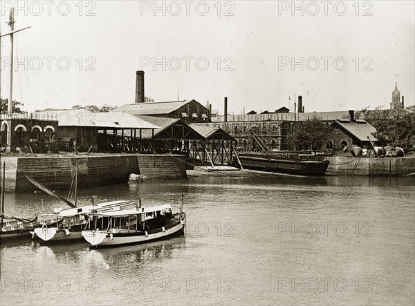 RIMS dockyard in Bombay. Boats moored in the harbour of a government dockyard belonging to the Royal Indian Marine Service. Bombay (Mumbai), India, circa 1900. Mumbai, Maharashtra, India, Southern Asia, Asia.