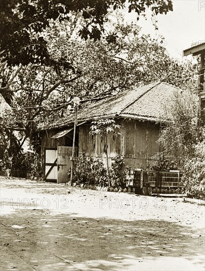 Road to the Bombay dockyard. A road leading to the slipways and boat sheds of a government dockyard belonging to the Royal Indian Marine Service. Bombay (Mumbai), India, circa 1900. Mumbai, Maharashtra, India, Southern Asia, Asia.