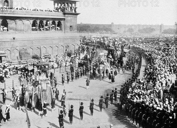 State entry procession at the Coronation Durbar. Crowds line the streets outside the Jama Masjid to watch the state entry procession of the Coronation Durbar. British dignitaries and Indian Maharajahs ride in howdahs on the backs of bejewelled elephants, amongst them Lord and Lady Curzon. Delhi, India, 29 December 1902. Delhi, Delhi, India, Southern Asia, Asia.