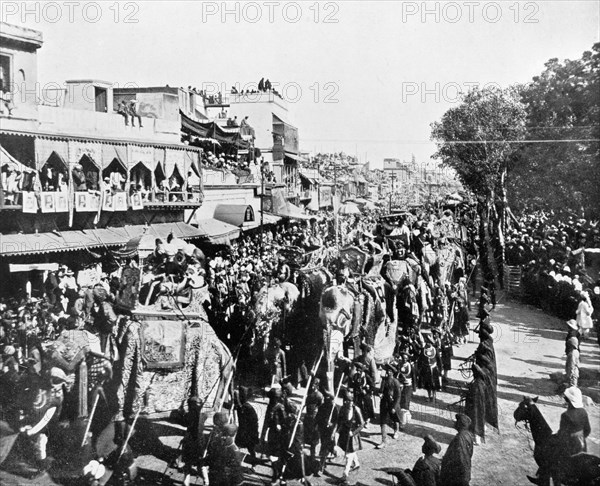 Procession through the Chandni Chowk. Crowds line the Chandni Chowk ('Silver Road') to watch the state entry procession of the Coronation Durbar. British dignitaries and Indian Maharajahs ride in howdahs on the backs of bejewelled elephants, amongst them Lord and Lady Curzon and the Duke and Duchess of Connaught. Delhi, India, 29 December 1902. Delhi, Delhi, India, Southern Asia, Asia.