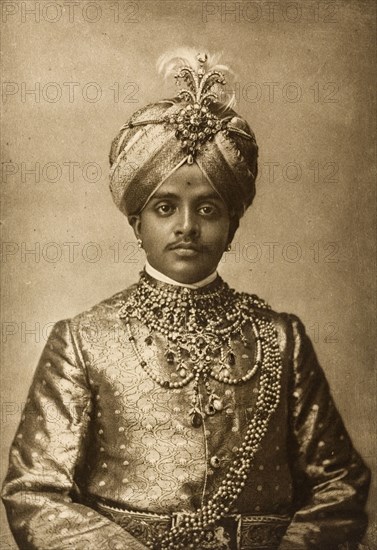 Maharajah of Mysore. Half-length studio portrait of Krishna Raja Wadiyar IV (1884-1940), Maharajah of Mysore, finely dressed for the Coronation Durbar at Delhi. India, circa 1902. India, Southern Asia, Asia.