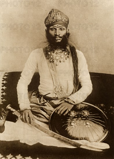 Sir Raghubir Singh. Studio portrait of Sir Raghubir Singh (1869-1927), Maharao Raja of Bundi, finely dressed for the Coronation Durbar at Delhi. India, circa 1902. India, Southern Asia, Asia.