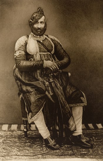 Maharajah of Datia. Studio portrait of the Maharajah of Datia, dressed in his robes for the Coronation Durbar at Delhi. India, circa 1902. India, Southern Asia, Asia.