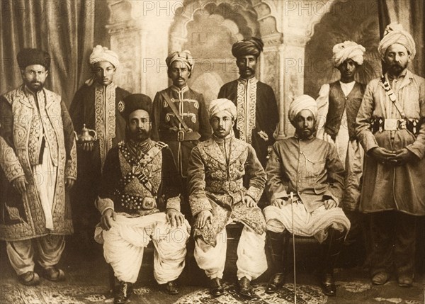 Pakistan chiefs dressed for the Coronation Durbar. Group studio portrait featuring the Khan of Dir, the Mehtar of Chitral and the Khan of Nawagai, all chiefs from Pakistan. They are all dressed in ceremonial attire for the Coronation Durbar at Delhi. India, circa 1902. India, Southern Asia, Asia.