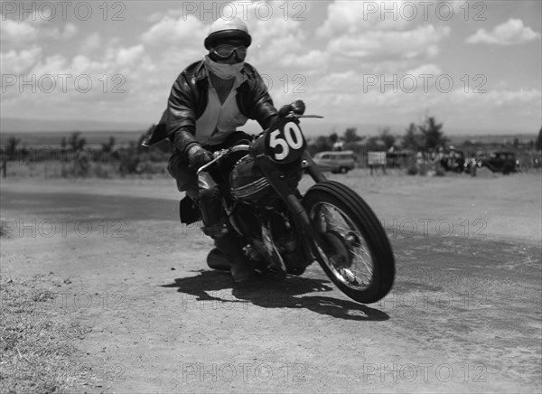 Number 50 in mid-race. Good is captured mid-race as he rides motorcycle number 50 in an event at the Langa Langa racing circuit. Langa Langa, Kenya, 13 October 1957. Langa Langa, Rift Valley, Kenya, Eastern Africa, Africa.