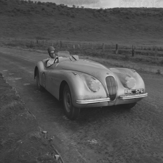 Mandeville competes at Langa Langa. Mandeville drives a powerful sports car in the last race of an event held at the Langa Langa racing circuit. Langa Langa, Kenya, 13 October 1952. Langa Langa, Rift Valley, Kenya, Eastern Africa, Africa.