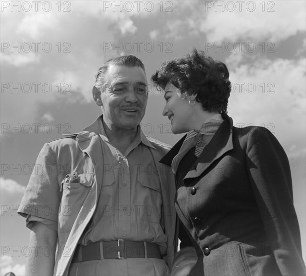 Clark Gable and Ava Gardner. Hollywood film stars Clark Gable and Ava Gardner share a private joke on their arrival at Eastleigh airport. Both were due to play leading roles in 'Mogambo', a John Ford film being shot on location in Kenya. Nairobi, Kenya, 7 November 1952. Nairobi, Nairobi Area, Kenya, Eastern Africa, Africa.