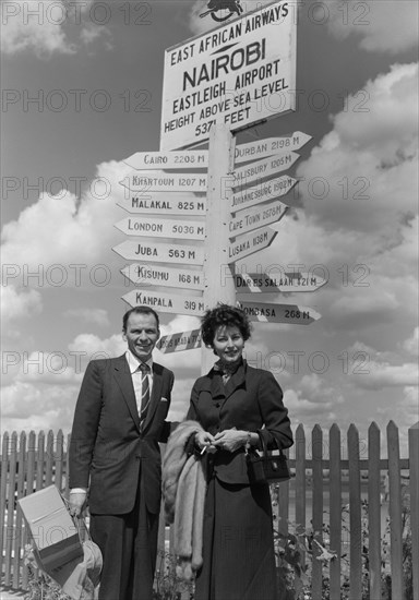 Frank Sinatra and Ava Gardner. Hollywood couple Frank Sinatra and Ava Gardner pose beneath a signpost on their arrival at Eastleigh airport. Gardner was due to play a lead role in 'Mogambo', a John Ford film being shot on location in Kenya. Nairobi, Kenya, 7 November 1952. Nairobi, Nairobi Area, Kenya, Eastern Africa, Africa.