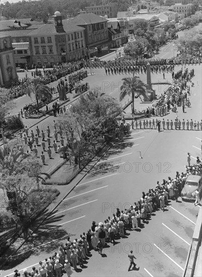 Armistice Day in Nairobi. View taken from the Torrs Hotel in central Nairobi of an Armistice Day memorial service. The streets surrounding the war cenotaph are closed for a military procession and crowds of onlookers line the pavements. Nairobi, Kenya, 9 November 1952. Nairobi, Nairobi Area, Kenya, Eastern Africa, Africa.