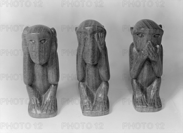 Hear no evil, see no evil, speak no evil. Three wooden ornaments, carved into the shape of monkeys. Kenya, 5 December 1952. Kenya, Eastern Africa, Africa.