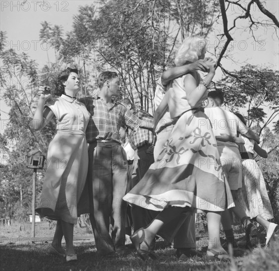 Square dance rehearsal. A group of dancers couple up to practice their routine for a square dance cabaret. Kenya, 7 December 1952. Kenya, Eastern Africa, Africa.