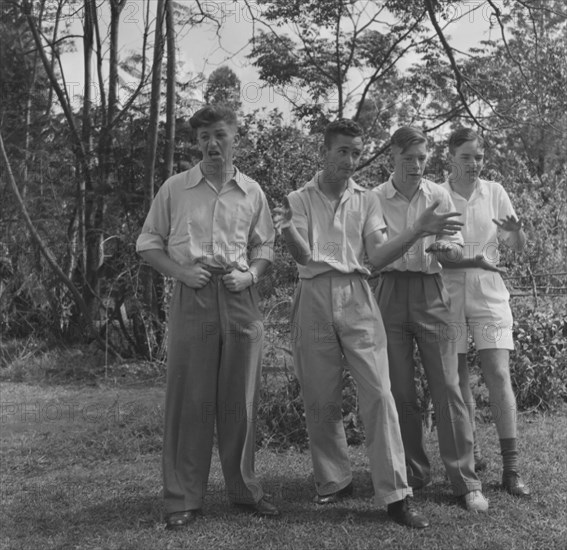Cabaret practice. Four young men strike a pose as they practice their cabaret routine for a square dance party. Kenya, East Africa, 14 December 1952. Kenya, Eastern Africa, Africa.