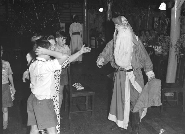 Father Christmas visits. Father Christmas visits a children's Christmas party at the Forest Inn. Possibly Nairobi, Kenya, 25 December 1952. Kenya, Eastern Africa, Africa.