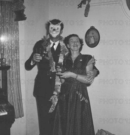 The Richardsons joke around. Mr and Mrs Richardson strike a humorous pose at the Archer's New Year's party. Kenya, 31 December 1952. Kenya, Eastern Africa, Africa.
