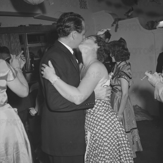 Kissing couple, Kenya. Mrs Archer and Eric Cecil are captured mid-embrace on the dancefloor at a New Year's party. Kenya, 31 December 1952. Kenya, Eastern Africa, Africa.