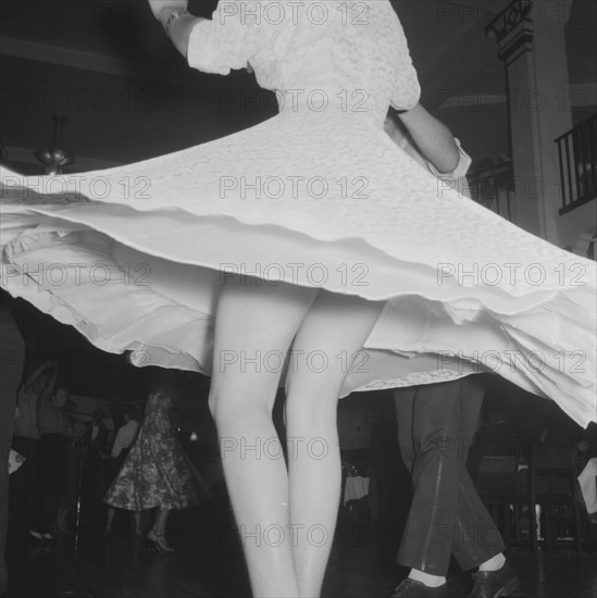 Spinning around. Close up shot of a girl's legs, appearing from beneath her dress which flares outwards as she is spun around by her partner during a Jazz Ball dance. Kenya, 21 September 1957. Kenya, Eastern Africa, Africa.