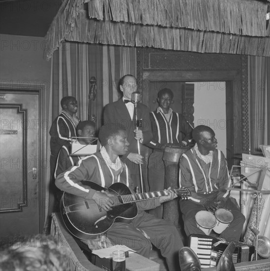 Band at the Equator Club. A European singer performs with a band of African musicians on stage at the Equator Club. Nairobi, Kenya, 21 September 1957. Nairobi, Nairobi Area, Kenya, Eastern Africa, Africa.