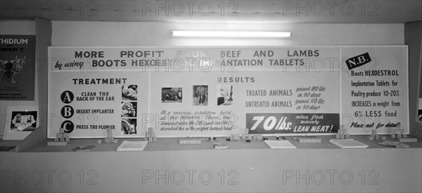 Advertising at the Royal Show. An advertising board on the Boots stand at the Royal Show promotes 'Hexoestrol Implantation Tablets', a veterinary drug used to improve weight gain in livestock. Kenya 25 September 1957. Kenya, Eastern Africa, Africa.