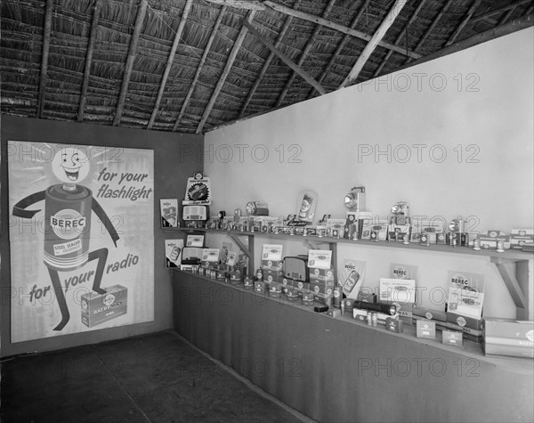 Berec batteries. Interior shot of the Berec stand at the Royal Show, headed by a large poster advertising Berec batteries 'for your flashlight and radio'.
Kenya 25 September 1957. Kenya, Eastern Africa, Africa.