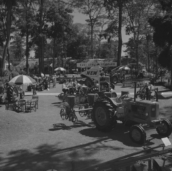 G & R agricultural machinery. A tractor and other agricultural machinery on display at the Gailey & Roberts stand, located in a shady clearing at the Royal Show. Kenya, 25 September 1957. Kenya, Eastern Africa, Africa.