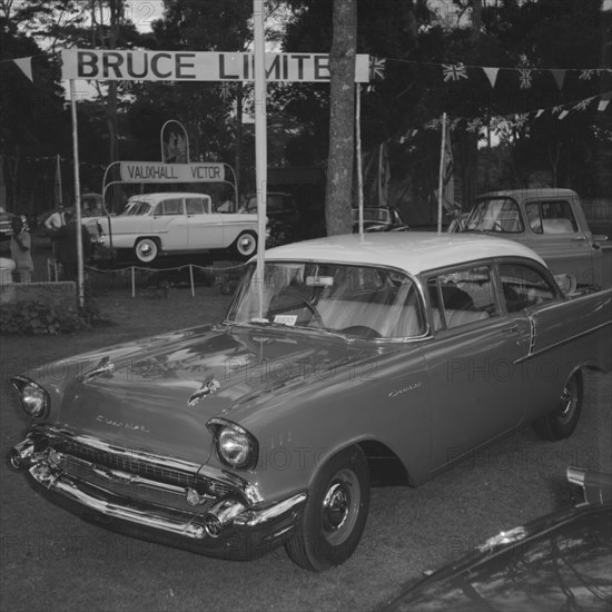 Motor Mart at the Royal Show. Shiny new cars on display at the Motor Mart stand at the Royal Show. Banners advertise trade names including 'Vauxhall Victor' and 'Bruce Limited'. Kenya, 25 September 1957. Kenya, Eastern Africa, Africa.